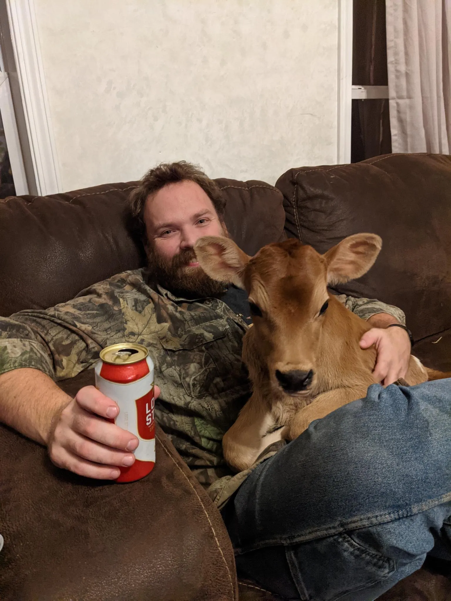 A new-born Elsa and I, sitting on a couch enjoying a beer.